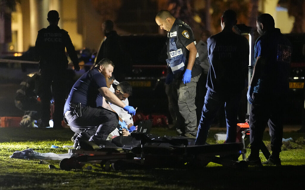 Technicians take fingerprints of the attacker who rammed his vehicle into a group of people, killing an Italisn tourist and wounding at least seven others, in Tel Aviv, Israel, Friday, April 7, 2023. (AP/Ariel Schalit)