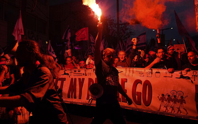 Israelis protest against plans by Prime Minister Benjamin Netanyahu's government to overhaul the judicial system, in Tel Aviv, Israel, Saturday, April 8, 2023. (AP Photo/Ariel Schalit)