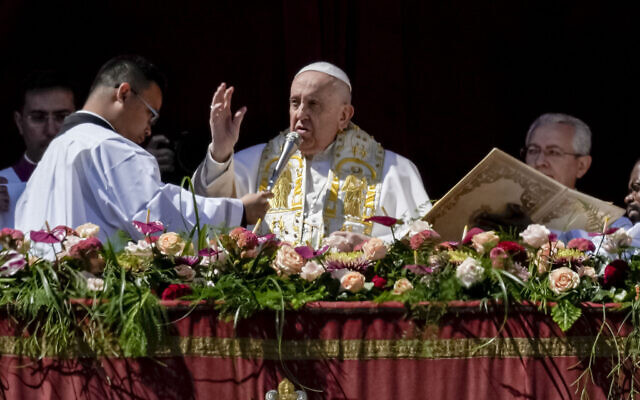Pope Francis bestows the plenary 'Urbi et Orbi' (to the city and to the world) blessing from the central lodge of the St. Peter's Basilica at The Vatican at the end of the Easter Sunday mass, Sunday, April 9, 2023. (AP/Alessandra Tarantino)