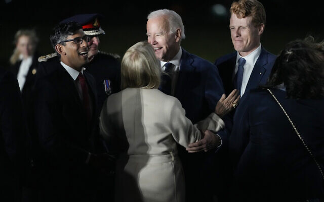 US President Joe Biden is greeted by British Prime Minister Rishi Sunak, left, and US Ambassador to the United Kingdom Jane Hartley, center, he steps off Air Force One at Belfast International Airport in Belfast, Northern Ireland, April 11, 2023. Biden is visiting the United Kingdom and Ireland in part to help celebrate the 25th anniversary of the Good Friday Agreement. At right is United States Special Envoy for Northern Ireland Joe Kennedy III. (AP Photo/Patrick Semansky)
