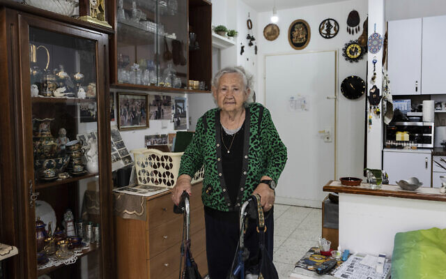 Holocaust survivor Tova Gutstein, 90, who lived in the Warsaw Ghetto as a child, poses for a photo at her apartment in the central city of Rishon Lezion, April 9, 2023. (AP Photo/Tsafrir Abayov)