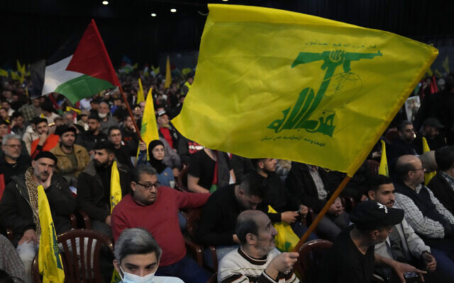 Hezbollah supporters wave their group and Palestinian flags, during a rally to mark Jerusalem day, in a southern suburb of Beirut, Lebanon, April 14, 2023. (AP Photo/Hussein Malla)