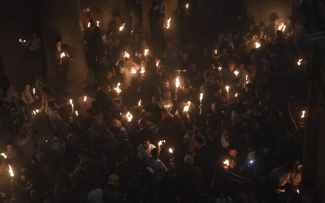Christians pilgrims hold candles during the Holy Fire ceremony, a day before Easter, at the Church of the Holy Sepulcher, in Jerusalem's Old City, April 15, 2023. (AP Photo/Mahmoud Illean)