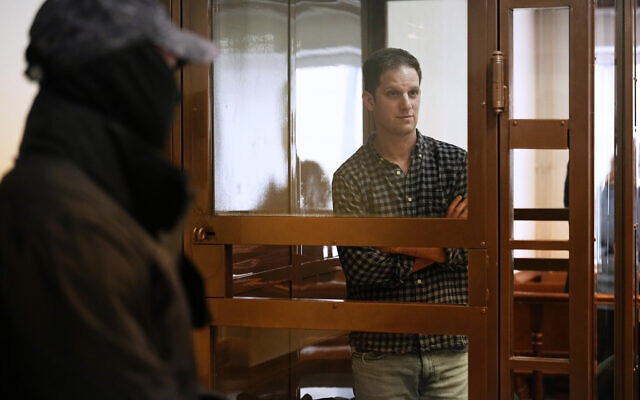 Wall Street Journal reporter Evan Gershkovich stands in a glass cage in a courtroom at the Moscow City Court, in Moscow, Russia, April 18, 2023. (AP Photo/Alexander Zemlianichenko)