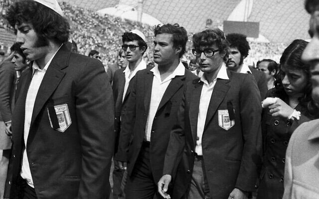 Members of Israel's Olympic team place black ribbons in their pockets after a memorial service mourning their comrades killed in the terrorist attack and subsequent police shoot-out, leave the Olympic stadium in Munich, then West Germany, Wednesday, Sept. 6, 1972.  (AP Photo, File)