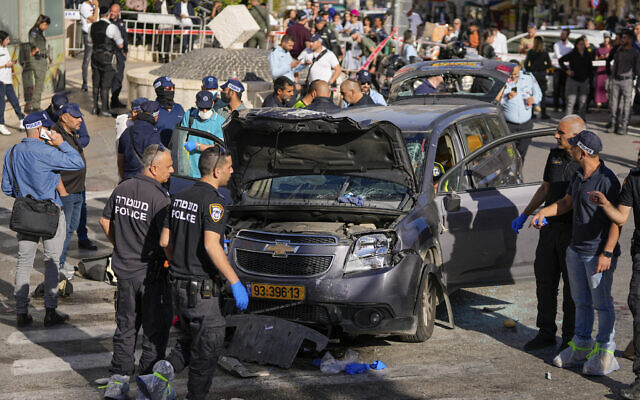 Israeli police examine the scene of a car ramming attack, in Jerusalem, Monday, April 24, 2023. (AP Photo/Ohad Zwigenberg)