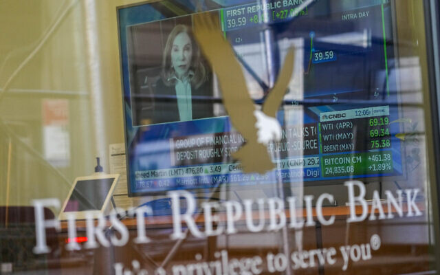 A television screen displaying financial news, including the stock price of First Republic Bank, is seen inside one of the bank's branches in New York's Financial District, on March 16, 2023. (AP Photo/Mary Altaffer, File)