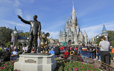 A statue of Walt Disney and Micky Mouse stands in front of the Cinderella Castle at the Magic Kingdom at Walt Disney World in Lake Buena Vista, Florida, January 9, 2019 (AP/John Raoux, File)
