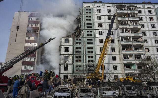 Firefighters work to extinguish a fire after a Russian attack at a residential building in Uman, central Ukraine, April 28, 2023. (AP Photo/Bernat Armangue)