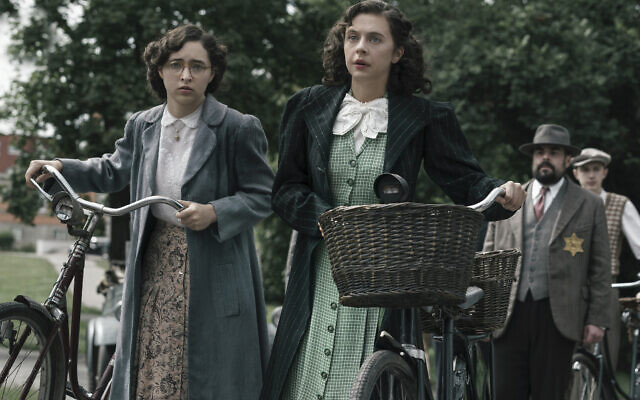 Margot Frank, played by Ashley Brooke, and Miep Gies, played by Bel Powley, arrive at a government checkpoint. (Photo credit: National Geographic for Disney/Dusan Martincek)
