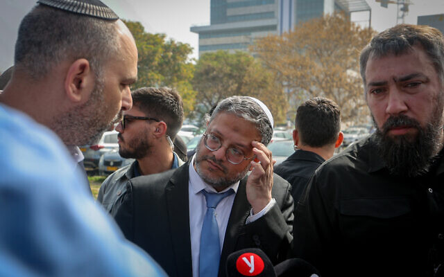 National Security Minister Itamar Ben Gvir, center, speaks with Lod Mayor Yair Revivo, left, during a tour of the city, April 17, 2023. (Flash90)