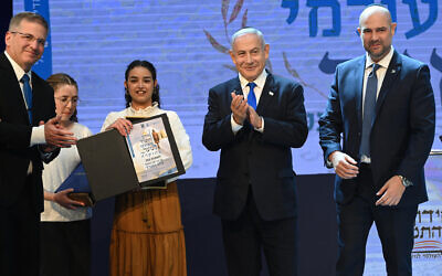 Prime Minister Benjamin Netanyahu and Knesset Speaker Amir Ohana (right) celebrate with Emunah Cohen, winner of the International Bible Quiz, April 26, 2023. (Haim Zach / GPO)
