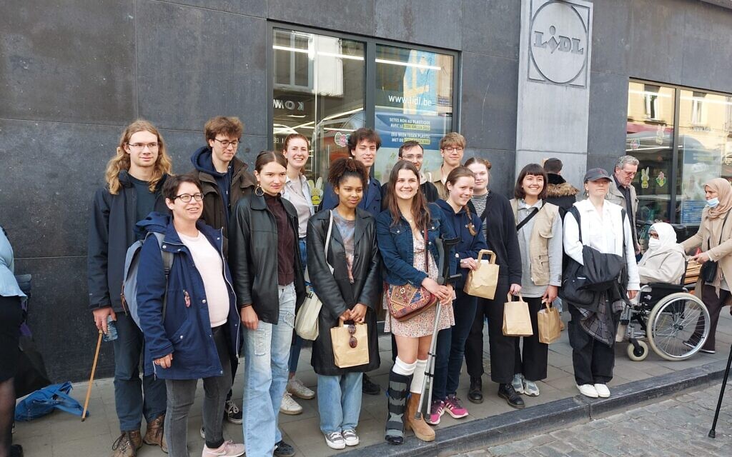 Volunteers from Action Reconciliation Service for Peace holding cleaning kits during the Yom Hashoah Stolpersteine cleaning event in Brussels, Belgium, co-organized with the European Jewish Association, April 27, 2022 (Courtesy of MakeTheirMemoryShine)