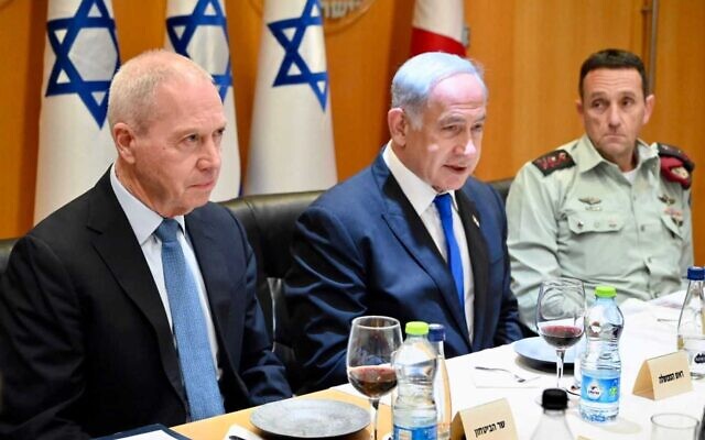 Defense Minister Yoav Gallant, left, and Prime Minister Benjamin Netanyahu at a pre-Passover toast, with Chief of Staff Herzi Halevi at right, April 4, 2023. (Ariel Hermoni/Defense Ministry)