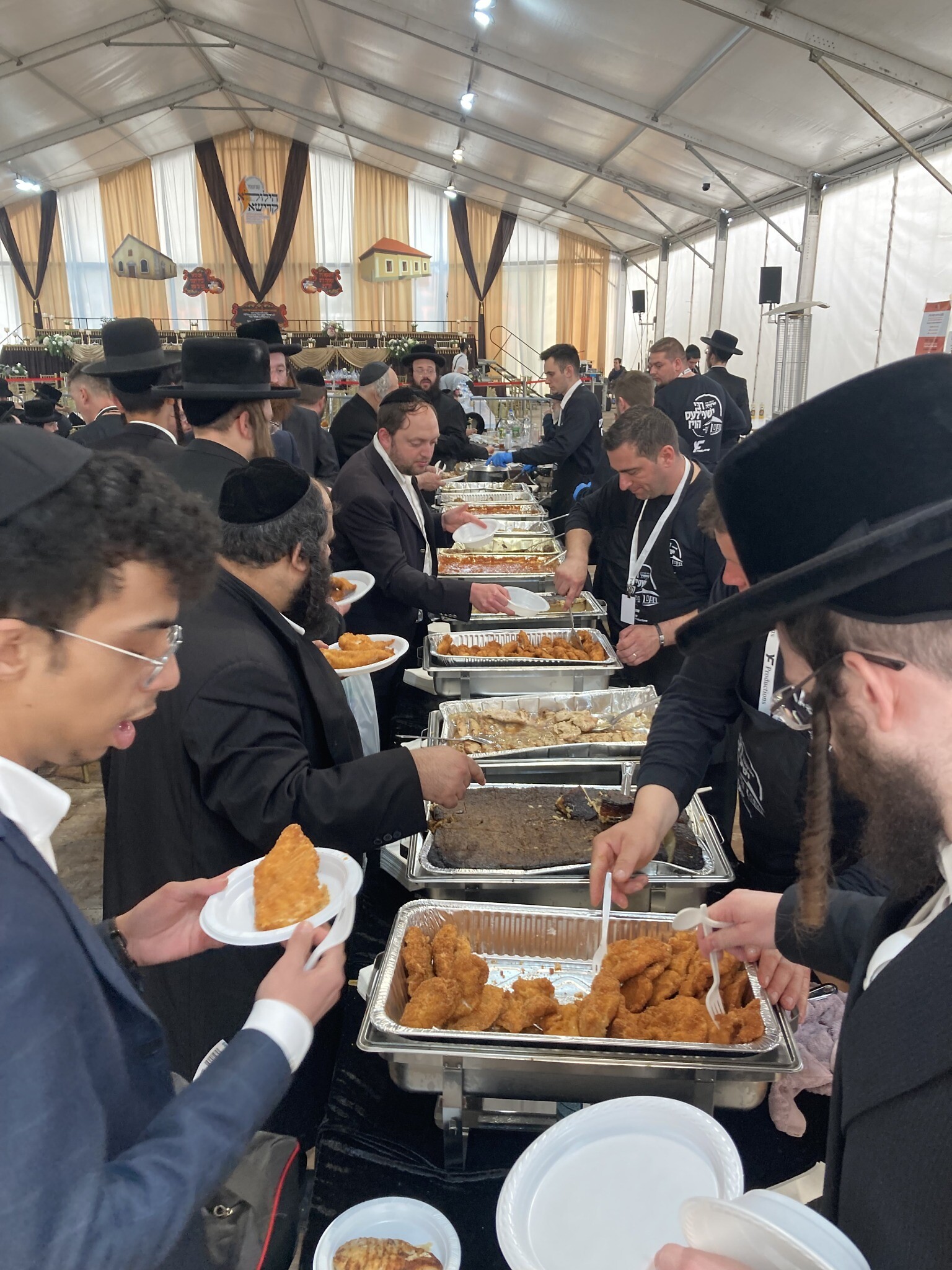 Free food is served at the annual pilgrimage to the gravesite of 'Reb Shayale' Steiner in Bodrogkeresztur, Hungary, April 24, 2023. (Yaakov Schwartz/ Times of Israel)