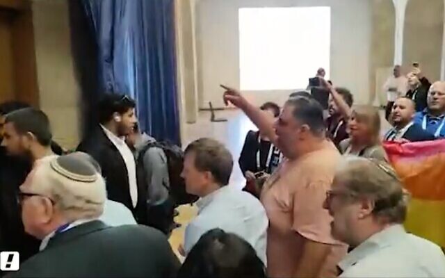 Protesters chant outside a room where judicial overhaul architect MK Simcha Rothman is holding a meeting at the World Zionist Congress in Jerusalem on April 21, 2023 (Screencapture/Walla:  used in accordance with Clause 27a of the Copyright Law)