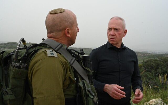 Defense Minister Yoav Gallant speaks with the commander of the IDF's Menashe Brigade, Col. Arik Moyal, April 9, 2023. (Ariel Hermoni/ Defense Ministry)