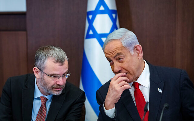 Prime Minister Benjamin Netanyahu, right, with Justice Minister Yariv Levin, left, during a cabinet meeting at the Prime Minister's Office, in Jerusalem on April 2, 2023. (Olivier Fitoussi/Pool)