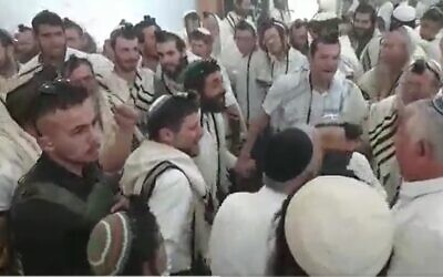 Finance Minister Bezalel Smotrich (center) and MK Zvi Sukkot (to his left) dance during a prayer service marking Independence Day in Homesh in the nothern West Bank, April 26, 2023. (Screenshot used in accordance with clause 27a of the Copyright Law)