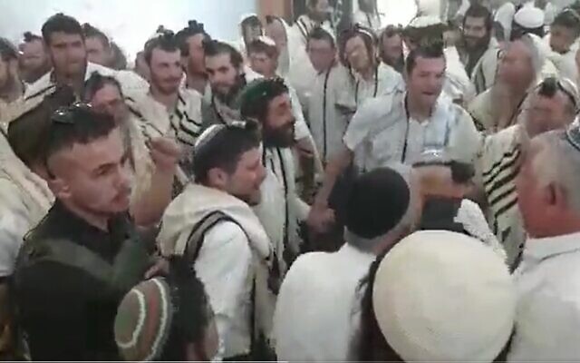 Finance Minister Bezalel Smotrich (center) and MK Zvi Sukkot (to his left) dance during a prayer service marking Independence Day in the illegal West Bank outpost of Homesh in the nothern West Bank, April 26, 2023. (Screenshot used in accordance with clause 27a of the Copyright Law)