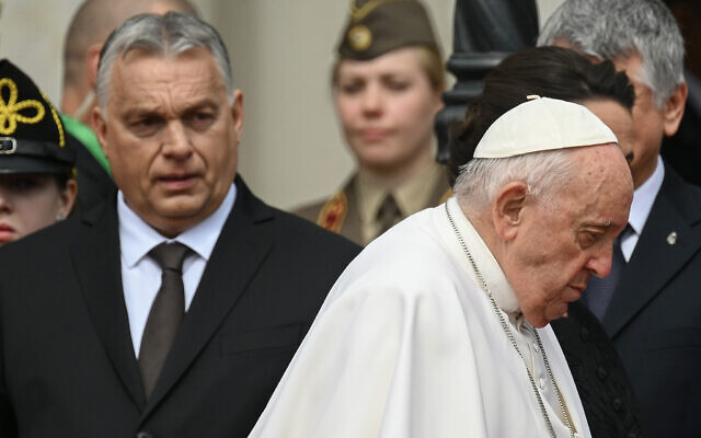 Hungary's Prime Minister Viktor Orban, left, looks on as Pope Francis walks away after a welcoming ceremony at Sandor Palace in Budapest on April 28, 2023. (Vincenzo Pinto/AFP)