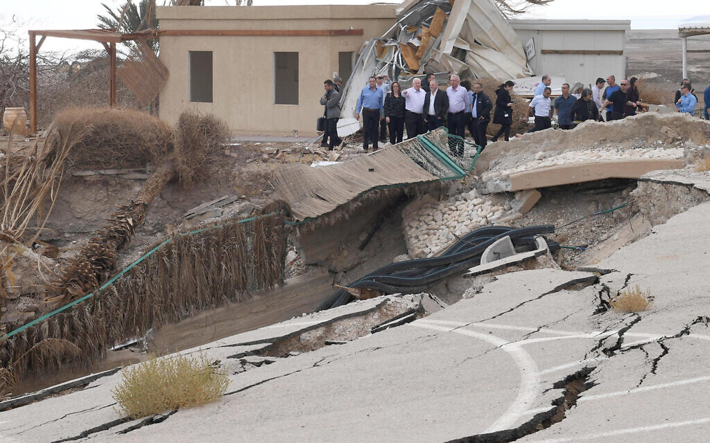 Israeli officials visit the site where a road collapsed into a large sinkhole at Mineral Beach in the Dead Sea on December 7, 2017. (Mark Neyman/GPO via JTA)