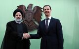 Syria's President Bashar al-Assad, right, shakes hands with his Iranian counterpart Ebrahim Raisi in Damascus on May 3, 2023. (Louai Beshara/AFP)
