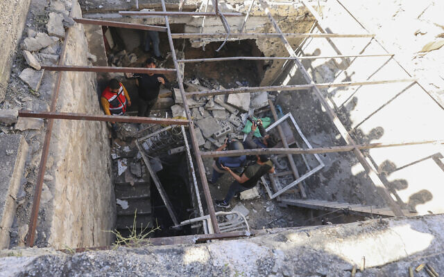 People inspect the site where three Palestinians were killed, during an Israeli raid in the West Bank city of Nablus on May 4, 2023. (Zain Jaafar / AFP)