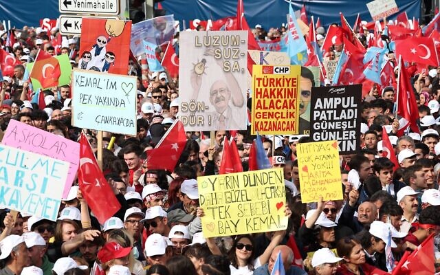 Supporters of Turkey's main opposition alliance hold placards as they attend a campaign rally of the alliance's presidential candidate Kemal Kilicdaroglu, ahead of general elections, in Ankara, on May 12, 2023.(Adem ALTAN / AFP)