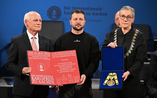 Ukraine's President Volodymyr Zelensky (center) is awarded the International Charlemagne Prize of Aachen 2023 by Juergen Linden (left), chairman of the Charlemagne Prize board of directors and Aachen's mayor Sibylle Keupen (right) on May 14, 2023 in Aachen, western Germany. (Federico Gambarini/ POOL/ AFP)