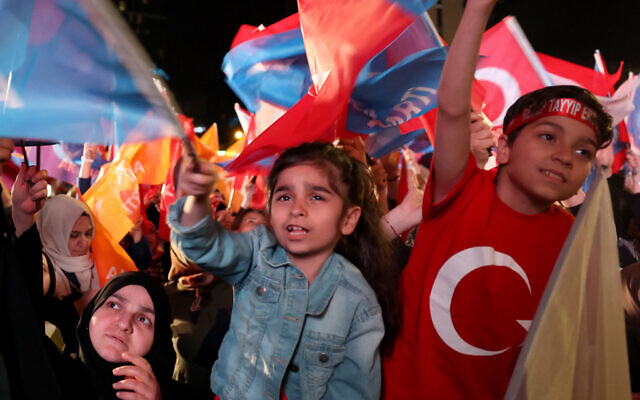 Supporters of Turkish President Recep Tayyip Erdogan wave flags as they wait for the results of Turkey's general elections on May 14, 2023. (Adem ALTAN / AFP)