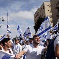 Israelis wave flags during the annual Jerusalem Day Flag March, May 18, 2023. (RONALDO SCHEMIDT / AFP)