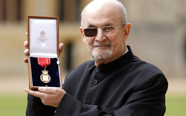 British author Salman Rushdie poses with his medal after being appointed as a Member of the Order of the Companions of Honour during an investiture ceremony at Windsor Castle on May 23, 2023. (Andrew Matthews / POOL / AFP)