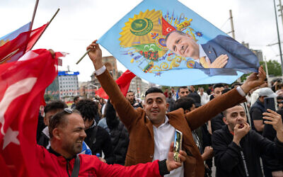 Supporters of Turkish President Recep Tayyip Erdogan hold flags depicting him, near Taksim Mosque in Istanbul, on May 28, 2023.  (Yasin Akgul/AFP)