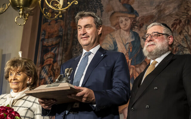 Bavaria’s Minister-President Markus Söder (center) receives an award from the Conference of European Rabbis, while standing alongside CER president Rabbi Pinchas Goldschmidt (right) and Charlotte Knobloch, head of the Jewish Community of Munich and Upper Bavaria, in Munich, May 9, 2023. (Marc Müller/CER)