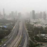 File: A view shows the skyline of Tel Aviv covered by a cloud of dust, on March 23, 2021. (Jack Guez/AFP)