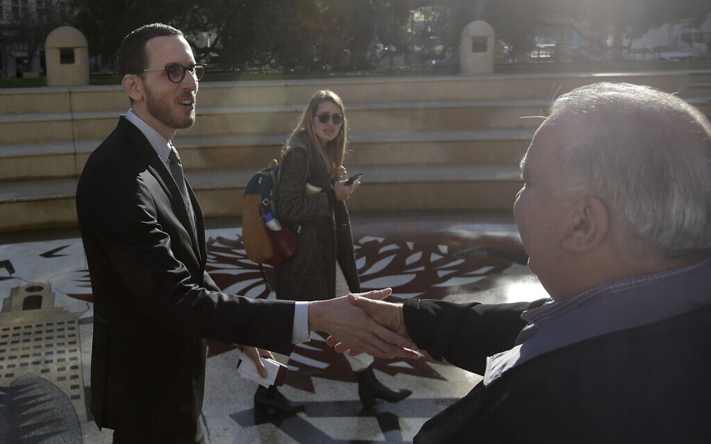 California Sen. Scott Wiener, left, shakes hands with a man after a rally for more housing outside of City Hall in Oakland, California, January 7, 2020. (AP Photo/Jeff Chiu, File)