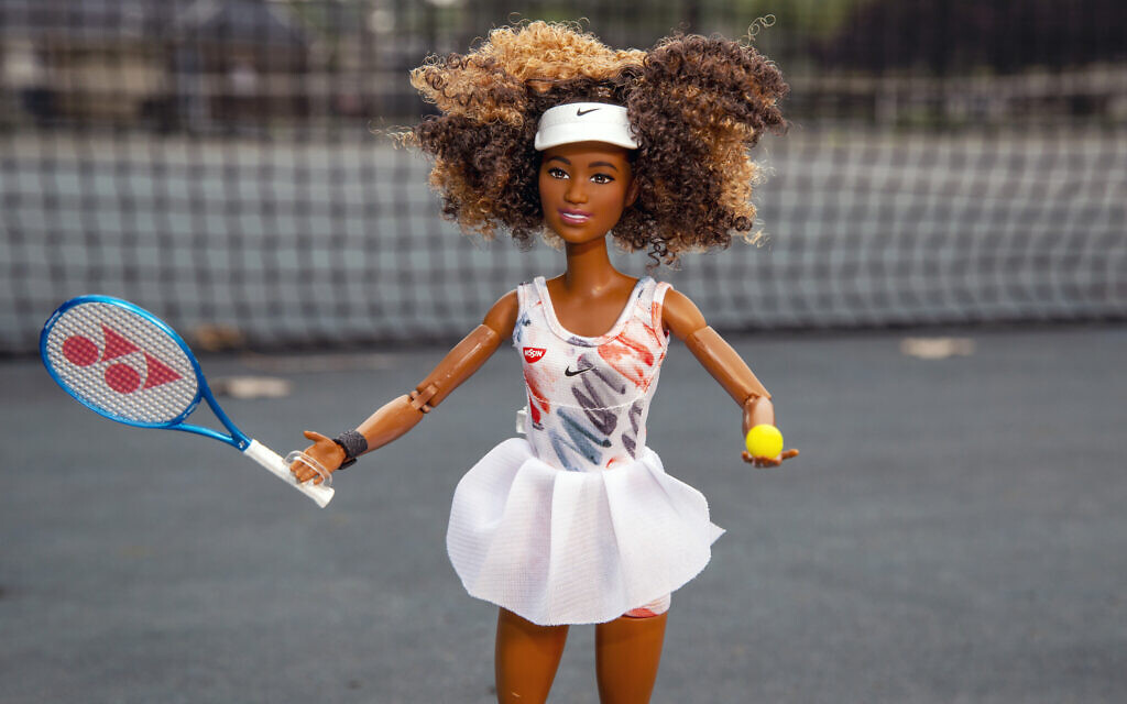 A Naomi Osaka Barbie doll is seen on a tennis court in Rutherford, New Jersey, July 12, 2021. Barbie launched the doll in the likeness of the world's highest-paid female athlete based on Osaka's outfit at the 2020 Australian Open. (AP Photo/Ted Shaffrey)