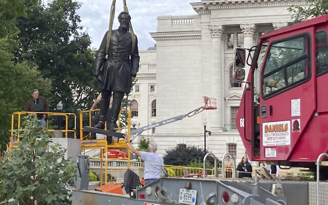 File: Workers reinstall a statue of Wisconsin abolitionist Col. Hans Christian Heg outside the state Capitol in Madison, Wisconsin on September 21, 2021. (AP Photo/Todd Richmond)