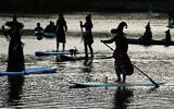 Illustrative: Participants dressed as witches ride paddleboards during the Medford Lakes Lions Witches Paddle Halloween event on October 22, 2022, in Medford Lakes, New Jersey. (Photo by Charles Sykes/Invision/AP)