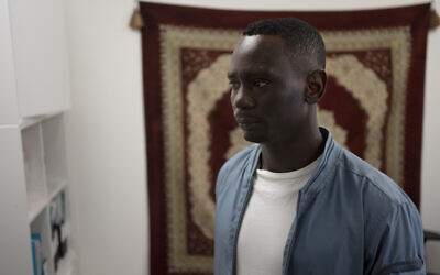 Omer Easa from Sudan poses for a portrait inside the offices of the Hotline for Migrant Workers, a rights group, in Tel Aviv, Israel, April 30, 2023 (AP/Maya Alleruzzo)
