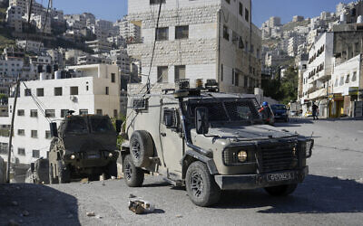 A convoy of Israeli military vehicles drives through the West Bank city of Nablus, during a raid, May 4, 2023. (AP Photo/Majdi Mohammed)