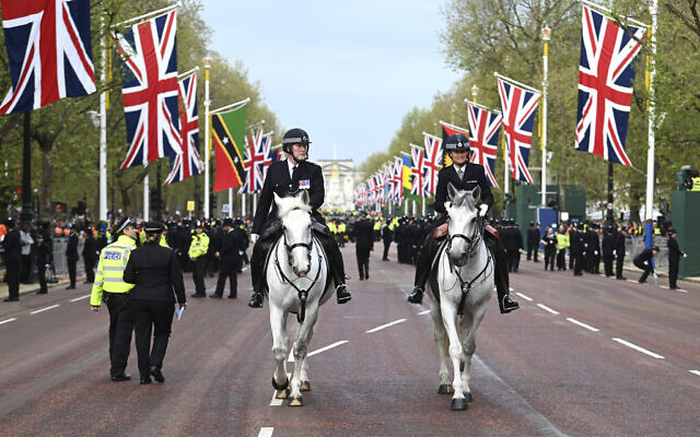 Mounted police officers are seen on the Mall ahead of the coronation of King Charles III in London, Saturday, May 6, 2023. (Charles McQuillan/Pool Photo via AP)