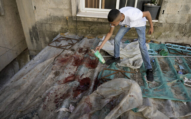 A boy looks at blood stains after an IDF  raid in the Nur Shams refugee camp near the city of Tulkarem, in the West Bank Saturday, May 6, 2023.  (AP Photo/Majdi Mohammed)