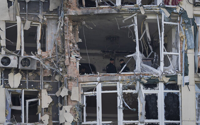 Police inspect an apartment building damaged by a drone, that was shot down during a Russian overnight strike, in Kyiv, Ukraine, Monday, May 8, 2023. (AP Photo/Andrew Kravchenko)