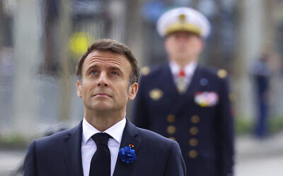French President Emmanuel Macron stands at the Tomb of the Unknown Soldier during ceremonies marking the 78th anniversary of the victory against the Nazis and the end of the World War II in Europe, in Paris, May 8, 2023. (Johanna Geron/Pool via AP)