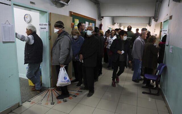 People stand in line as they wait to vote at a polling station in Ankara, Turkey, May 14, 2023. (AP Photo)