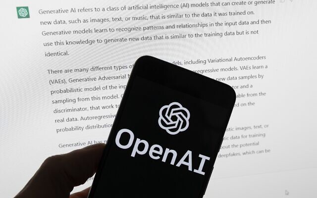 File: The OpenAI logo is seen on a mobile phone in front of a computer screen displaying output from ChatGPT, March 21, 2023, in Boston. (AP/Michael Dwyer)