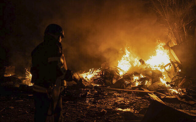In this photo provided by the Ukrainian Emergency Situations Ministry, firefighters put out fire caused by fragments of a Russian rocket after it was shot down by air defense system during the night Russian rocket attack in Kyiv, Ukraine, early Tuesday, May 16, 2023. (Ukrainian Emergency Situations Ministry via AP)