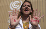 File: A demonstrator shows her hands reading '1.5 to survive' at a protest advocating for the warming goal at the COP27 U.N. Climate Summit, Nov. 16, 2022, in Sharm el-Sheikh, Egypt.  (AP/Peter Dejong)